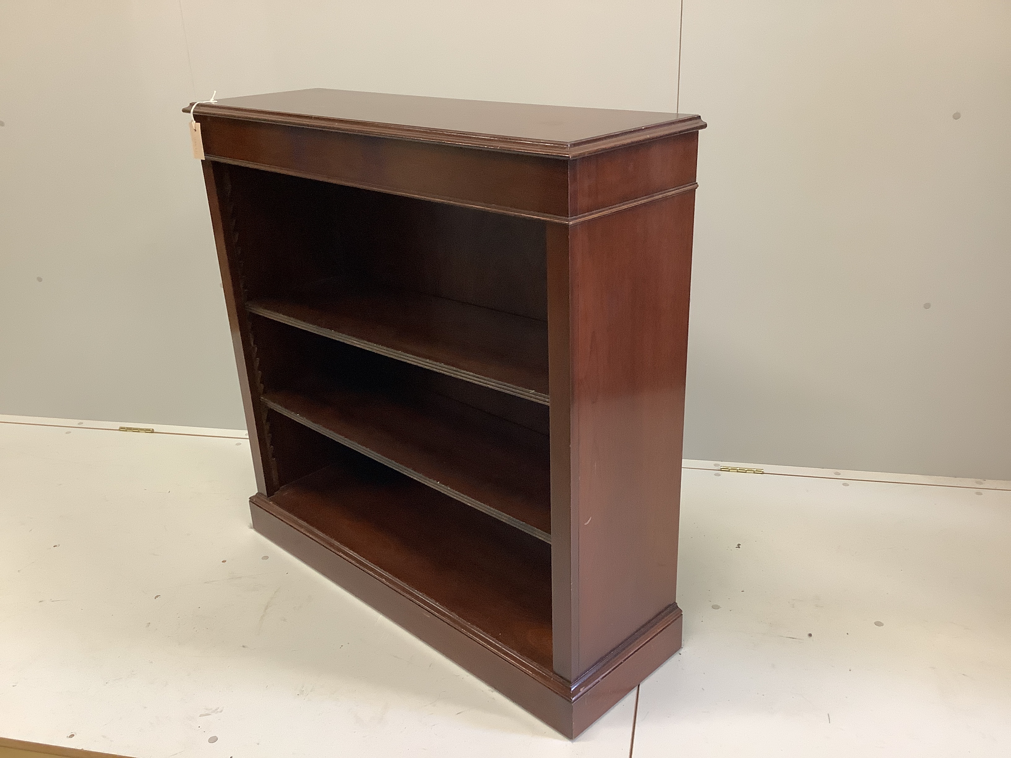 A reproduction Victorian style mahogany open bookcase, width 102cm, depth 32cm, height 100cm